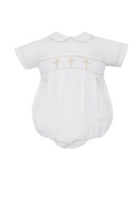 The perfect Easter outfit for your little one! Our White Poplin Boys Cross Embroidered Bubble from Petit Bebe features beautiful gold crosses embroidered across the bodice, a classic peter pan collar, and short sleeves. This delicate and elegant design is perfect for any religious ceremony or special occasion.