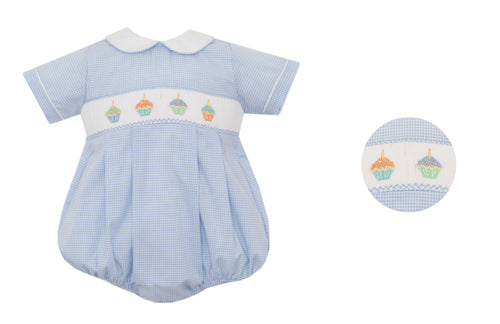 Celebrate your little boy's birthday with our Light Blue Gingham Cupcake Bubble! This adorable outfit features a short sleeve, peter pan collar, and smocked cupcakes across the bodice. Perfect for any birthday party, it's a sweet and stylish way to dress up your little one.