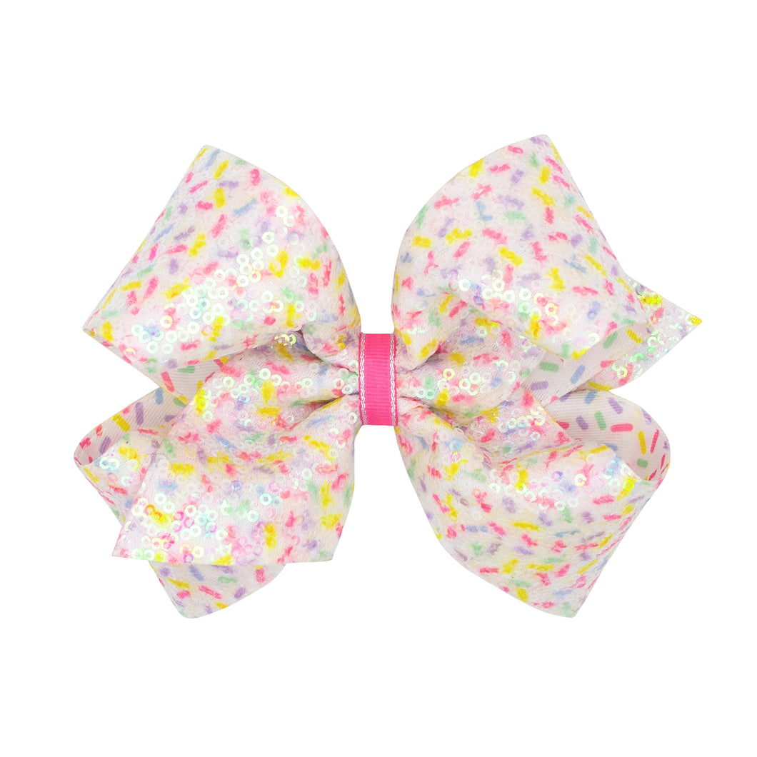 This Sequin Confetti Print Bow from Wee Ones is the perfect accessory for any birthday or everyday wear! The bow sparkles and shines with its sequin confetti print, adding a touch of fun and flair to any outfit. Available in two sizes, this versatile bow is a must-have for anyone who loves a bit of sparkle and shine. Add it to your collection today!