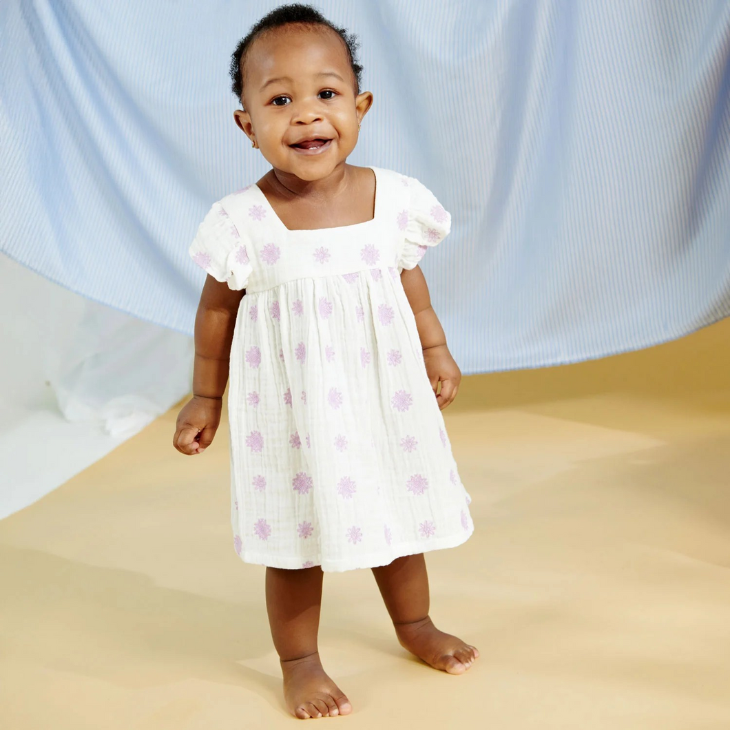 The Magnetic Me Lilac Embroidered Cotton Dress is perfectly fit for a fashionista with an empire waist and a flowy silhouette. when getting dressed presents its challenges, reach for this—magnetic closures make pulling it over the head much more manageable. crafted from 100% organic cotton, it's designed to hold up for special occasions and roughing around. 