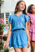 Load image into Gallery viewer, Girls Lola Dress in Blue Introducing our fresh Spring 2026 silhouette—the Lola Dress in Blue. This lightweight charmer features a flattering cinched waist paired with delicate tiered ruffle cap sleeves and a graceful knee-length skirt that moves with ease. Perfect for garden parties, family gatherings, or everyday outings, the Lola delivers effortless polish and timeless appeal. A versatile wardrobe essential that keeps her looking polished without the fuss.
