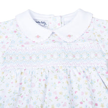 Load image into Gallery viewer, Treat your little one to ultimate comfort with Clara&#39;s Classics Smocked Collared Footie Pajamas. Made by Magnolia Baby, these adorable footie pajamas feature a delicate floral print and smocking detail, perfect for infant girls. Give her the sweetest sleep in these cozy, stylish pajamas.
