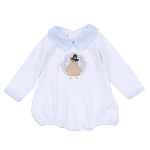 Dress your little one in festive charm with the Pilgrim Pals Applique Collared Bubble by Magnolia Baby. Crafted from soft pima cotton, this bubble ensures gentle comfort for delicate skin. The blue and white check collar adds a classic touch, while the adorable turkey 
