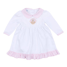 Load image into Gallery viewer, Dress your little one in festive charm with the Pilgrim Pals Applique Collared Dress by Magnolia Baby. Crafted from soft pima cotton, this dress ensures gentle comfort for delicate skin. The pink and white check collar adds a classic touch, while the adorable turkey &quot;Pilgrim&quot; applique brings a playful Thanksgiving spirit. Perfect for celebrating the season in style, this dress combines softness and sweetness for your infant girl’s special moments. Diaper cover is included.
