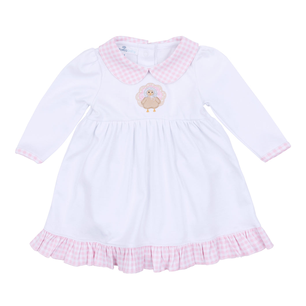 Dress your little one in festive charm with the Pilgrim Pals Applique Collared Dress by Magnolia Baby. Crafted from soft pima cotton, this dress ensures gentle comfort for delicate skin. The pink and white check collar adds a classic touch, while the adorable turkey 
