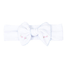 Load image into Gallery viewer, Add a touch of elegance to your little girl&#39;s outfit with Charlotte&#39;s Classics Embellished Headband. Featuring stunning blue embroidery and delicate rosettes, this headband from Magnolia Baby is perfect for infant girls. Elevate any look and make your little one feel like a princess. Pairs perfectly with other styles within the Charlotte&#39;s Classics Collection.
