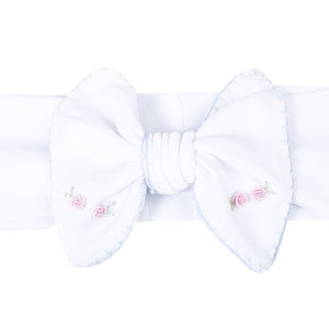 Add a touch of elegance to your little girl's outfit with Charlotte's Classics Embellished Headband. Featuring stunning blue embroidery and delicate rosettes, this headband from Magnolia Baby is perfect for infant girls. Elevate any look and make your little one feel like a princess. Pairs perfectly with other styles within the Charlotte's Classics Collection.