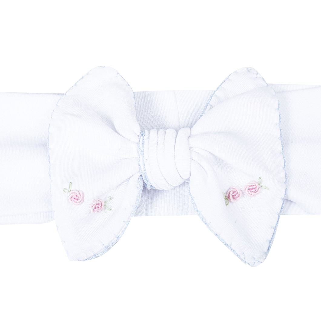 Add a touch of elegance to your little girl's outfit with Charlotte's Classics Embellished Headband. Featuring stunning blue embroidery and delicate rosettes, this headband from Magnolia Baby is perfect for infant girls. Elevate any look and make your little one feel like a princess. Pairs perfectly with other styles within the Charlotte's Classics Collection.