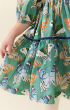 Load image into Gallery viewer, Pink Chicken’s Girls Maribelle Dress in Green Butterflies brings playful elegance to every twirl. The delicate butterfly print and navy velour ribbon trim create a charming look that delights and inspires confidence in every step. Perfect for joyful moments and unforgettable memories!

