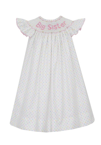 Get your little one ready for her role as Big Sister with this elegant and sweet Bishop dress by Anavini. The white polka dotted smocked dress is adorned with delicate pink embroidery that reads 
