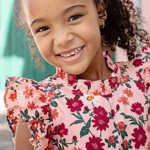 Fresh As A Daisy! A patch of wild daisies in shades of red, orange and white springs from a blush colored ground in our Pink Daisy Floral shown here on our Girls Jennifer Dress. This short sleeve flock favorite silhouette delights with its feminine ruffled neck and sleeves and fully gathered, two tiered skirt that spins like a dream. Invisible zipper. A silver thread woven throughout adds a touch of shimmer and shine. Match back to Little Sis in our Baby Girls Jennifer Bubble.&nbsp;