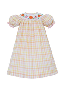 Celebrate autumn charm with the Girl's Pumpkin Smocked Gingham Bishop Dress from Petit Bebe. This delightful dress showcases a delicate smocked neckline adorned with embroidered pumpkins, perfectly paired with a timeless gingham print. Its classic bishop sleeve design offers both elegance and comfort, making it ideal for festive occasions or everyday wear.&nbsp;