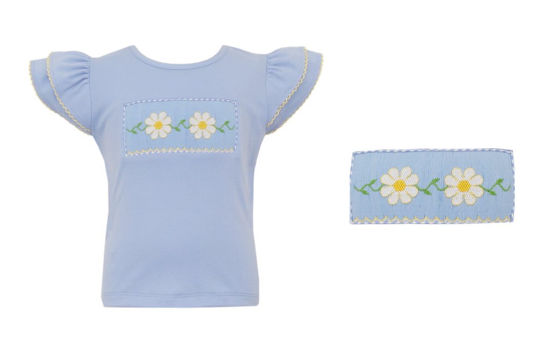 Add some flowery charm to your little girl's wardrobe with our Girls Daisies Smocked Flutter Sleeve Tee! The light blue color and yellow moonstitch details perfectly complement the smocked daisy design on the front, while the flutter sleeves add a touch of whimsy. Available now from Anavini. Pair with the Seersucker check shorts for the perfect outfit!