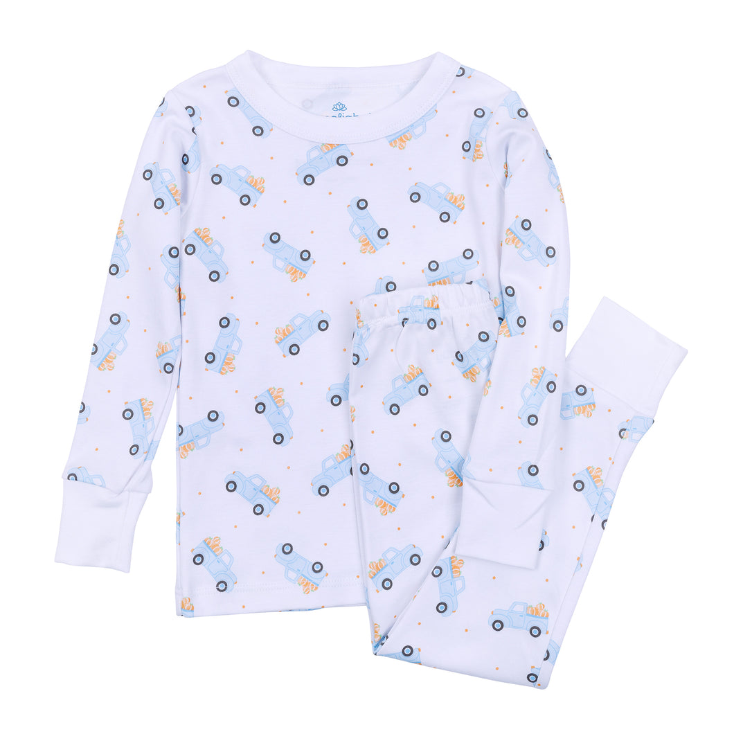 Made from 100% soft pima cotton, these Boys Pumpkin Patch Truck Long Pajamas from Magnolia Baby offer cozy comfort for a restful night. Featuring a charming blue truck carrying pumpkins on a crisp white background, this classic long sleeve set combines playful style with breathable fabric, perfect for your little one’s bedtime or lounging around the house.