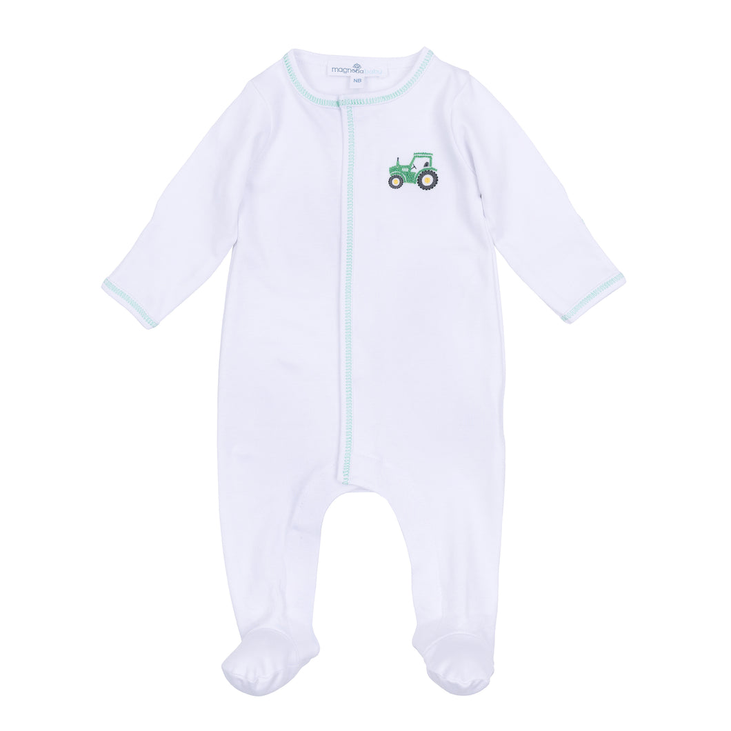 Dress your little one in comfort and charm with the Lil' Green Tractor Embroidered Footie from Magnolia Baby. This soft white footie features convenient snaps for easy changes and delicate green stitching that highlights a playful embroidered tractor on the front. Perfect for everyday wear, it combines practicality with adorable style to keep your baby cozy and looking cute all day long.