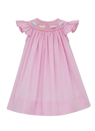 Dress up your little girl in our Girl's Cupcake Smocked Bishop Dress by Petit Bebe. This charming pink and white gingham dress is adorned with delightful cupcake smocking, making her look sweet as can be!