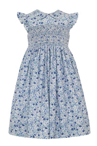 Experience the perfect combination of elegance and style with our Girls Floral Float Smocked Dress from Anavini! This beautiful dress boasts a vibrant blue floral pattern, smocked bodice, flutter sleeves, and peter pan collar. From toddler to young girls, this dress will make your little one stand out in any occasion.