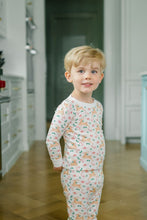 Load image into Gallery viewer, The Proper Peony’s Prancer Pima Pajama Set wraps your little one in soft, breathable Pima cotton, featuring charming reindeer and candy cane prints that bring festive joy to Christmas mornings. Cozy, cute, and perfect for holiday memories that last a lifetime!
