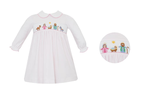 Celebrate the season in timeless elegance with this charming Girl's Knit Pink Stripe Nativity Dress from Petit Bebe. Crafted in soft light pink and white mini stripes, this knee-length dress features a delicate peter pan collar and exquisite hand-embroidered nativity scene across the bodice. Each stitch tells a story of holiday tradition, while the adjustable back tie ensures a perfect fit. Long sleeves provide warmth for festive gatherings, making this the ideal choice for creating lasting memories in clas