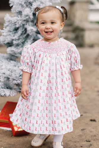 Celebrate the festive season in style with the Girls Kate Cowboy Christmas Dress from Shop Teeta. This charming dress features a playful Christmas and cowboy boots print that brings a touch of whimsy to your little one’s wardrobe. The smocked neckline adds a classic, comfortable fit, making it perfect for holiday gatherings and everyday fun. 