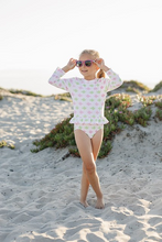 Load image into Gallery viewer, Get ready to make a splash with our Girly Fish Rash Guard One Piece Swimsuit! Designed by Funtasia Too, this adorable swimsuit features a cute pink and green fish design on a white background. The rash guard style and ruffle waist accent make it both stylish and practical for your little one. Dive in now!
