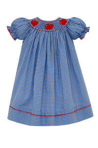 The Girl's Apple Bishop Gingham Dress from Anavini combines classic charm with playful details. Featuring a delicate smocked neckline adorned with red apple embroidery, this blue and white check dress is accented by a vibrant red hem. Its timeless design and comfortable fit make it an ideal choice for back-to-school days, ensuring your little one looks both stylish and ready for the classroom.