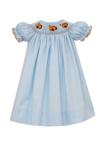 Celebrate Thanksgiving in timeless style with this Girls Blue Twill Turkey Smocked Bishop Dress. Crafted from soft blue twill, it features delicate hand-embroidered turkeys on expertly smocked detailing, making it a charming choice for holiday gatherings. Perfect for creating unforgettable sibling photos, coordinating matching outfits are available to complete the festive look.