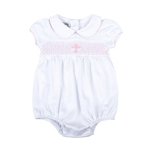 Wrap your little one in love and blessings with our Girls Pink Smocked Blessed Bubble. Made from soft, high-quality fabric, this bubble features delicate pink smocking and a beautiful cross detail, perfect for any special Baptism and religious occasion. With its classic peter pan collar, your little girl will look and feel blessed.