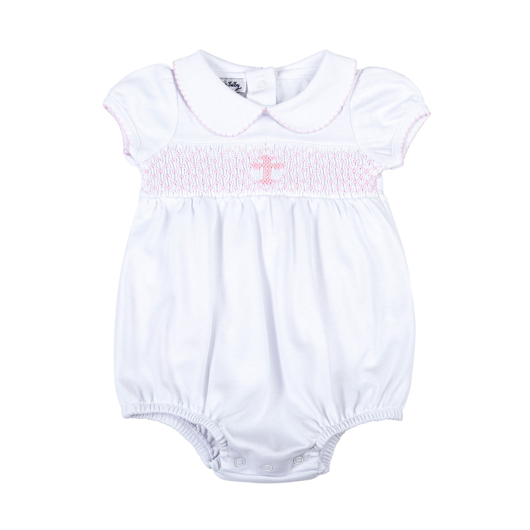 Wrap your little one in love and blessings with our Girls Pink Smocked Blessed Bubble. Made from soft, high-quality fabric, this bubble features delicate pink smocking and a beautiful cross detail, perfect for any special Baptism and religious occasion. With its classic peter pan collar, your little girl will look and feel blessed.