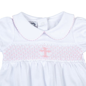 Wrap your little one in love and blessings with our Girls Pink Smocked Blessed Bubble. Made from soft, high-quality fabric, this bubble features delicate pink smocking and a beautiful cross detail, perfect for any special Baptism and religious occasion. With its classic peter pan collar, your little girl will look and feel blessed.