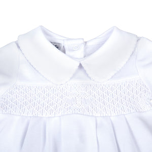 Give your little one a stylish and meaningful look with our Infant Blessed Bubble from Magnolia baby. This adorable bubble features a classic peter pan collar, white smocking, and a cross detail to symbolize blessings. Dress them in comfort and style for any Baptism or religious occasion.