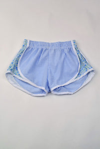 Upgrade your little girl's athletic wardrobe with our Blue Gingham &amp; Floral Track Shorts from Funtasia Too! These stylish blue shorts feature a beautiful floral accent on the sides, adding a touch of feminine charm to her sporty look. Perfect for pairing with the Angel Tee!