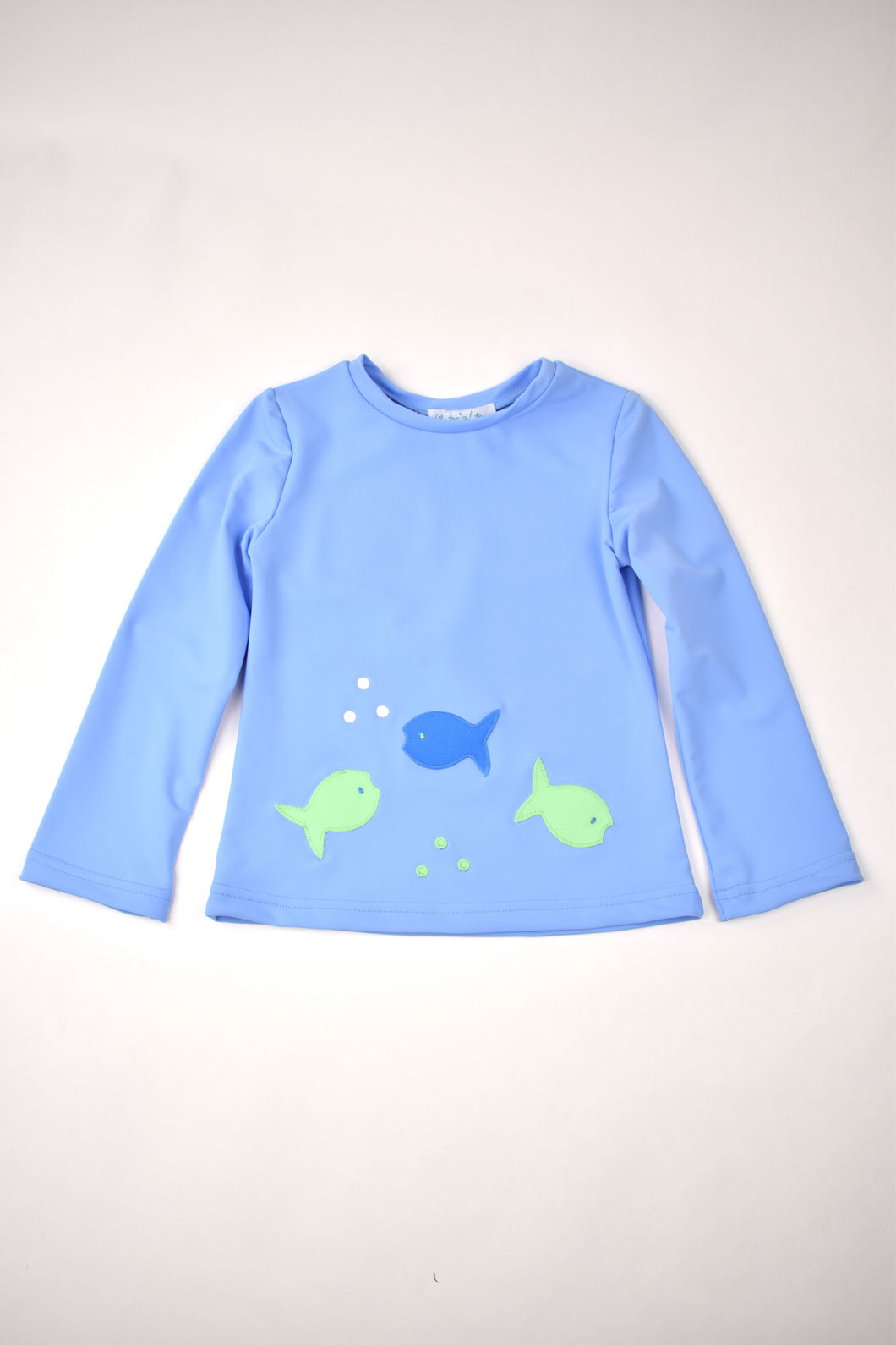 Protect your little one from the sun in style with our Blue Fish Rash Guard from Funtasia Too! The classic blue color and fun fish applique details make this rash guard both functional and fashionable. Complete the look with our Fish Swim Trunks for a perfect beach day outfit.
