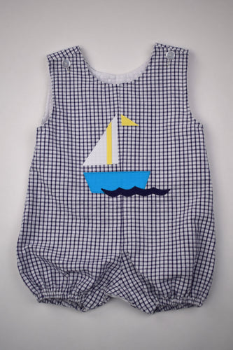 Sail away in style with our Sailboat Gingham Bubble! Designed for toddler boys, this bubble features a charming navy and white gingham print with a playful sailboat applique. Perfect for any summer adventure, this bubble will keep your little one cool and comfortable.