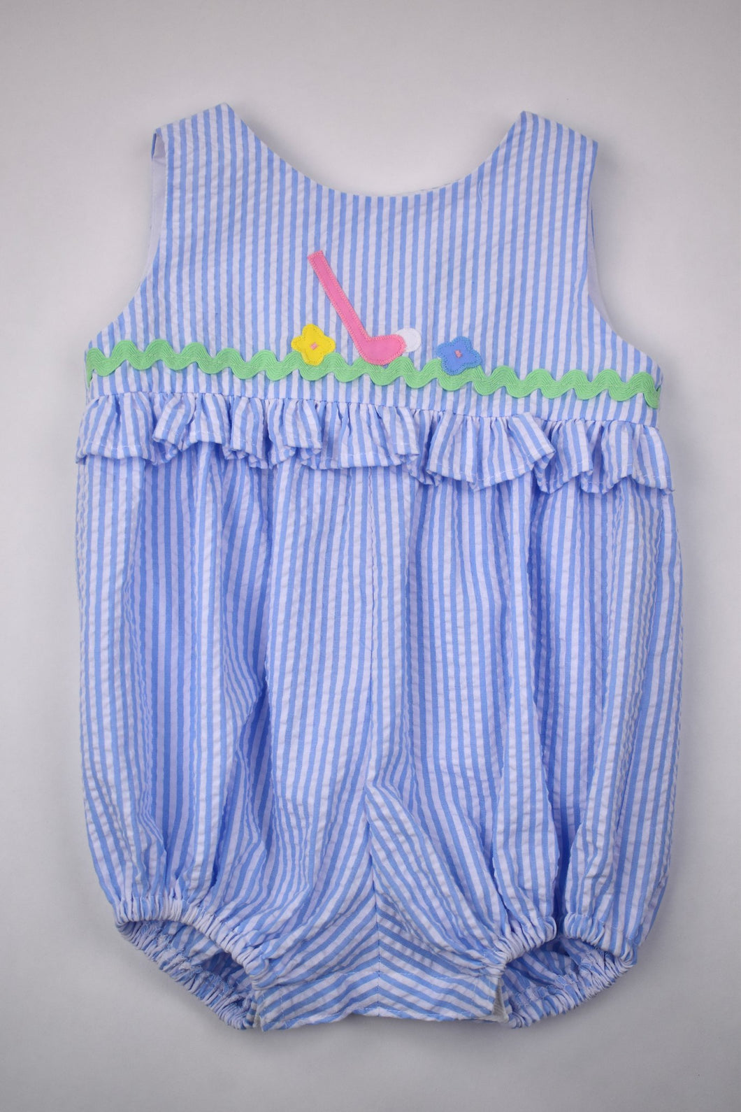 Upgrade your little girl's summer wardrobe with our Club & Flowers Bubble from Funtasia Too! This adorable bubble features blue and white seersucker stripes with a charming golf club and flowers applique. Perfect for a day out on the course, this bubble will keep your little one cute and comfortable.