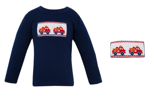 The Boys Smocked Navy Knit Stripe Firetruck Tee by Anavini combines comfort and charm with its soft, long-sleeve knit fabric. Highlighted by a detailed smocked and embroidered firetruck design, this tee adds playful style to any little boy’s wardrobe!