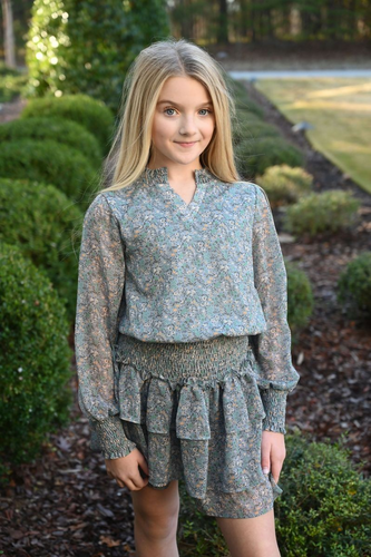 The Harriett Dress in Marigolds by Pleat combines delicate chiffon fabric with a vibrant floral print, creating an effortlessly elegant look. Its flattering v-neckline and flowing tiered skirt add movement and charm, perfect for special occasions or everyday wear. Embrace comfort and style with this beautifully crafted dress that brightens any wardrobe.