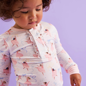 The Pretty Plies Pajama Set from Magnetic Me combines charming ballerina-themed design with effortless comfort. Featuring a magnetic front top detailed with delicate ruffles and coordinating pants, this set is crafted from soft, stretchy modal fabric that moves with your child. Perfect for bedtime or lounging, these pajamas offer cozy wear and easy dressing, making nighttime routines smooth and enjoyable. Embrace comfort and style in one delightful set.