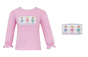 Introducing our Ballet Dancer Knit Tunic for Girls. Made with soft cotton material and featuring a delicate ruffle detail, this shirt is perfect for your little dancer. The smocked ballet design adds a touch of elegance to any outfit. Perfect for playtime or as a stylish addition to any wardrobe.