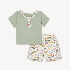 The Reel Good Time Pajama Short Set from Magnetic Me offers cozy comfort with a playful twist. Featuring a soft green shirt accented by a charming fish print along the collar and matching shorts, this set is perfect for little anglers ready to reel in sweet dreams. Its breathable fabric ensures all-night comfort, making bedtime a fun and relaxing adventure.