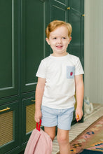 Load image into Gallery viewer, Dress your little boy in the charming Apple Pocket Shirt Short Set by The Proper Peony. The soft white Pima cotton shirt, featuring an adorable apple pocket, pairs perfectly with light blue shorts. It's not just stylish—it's incredibly comfortable, making it ideal for school days or playful adventures!
