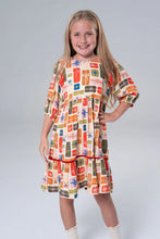 Load image into Gallery viewer, Briton Court’s Hattie Present Dress delights with its soft cream knit and charming present print. Vibrant orange velvet ribbons add playful warmth, making it perfect for joyful celebrations and everyday magic—from toddlers to tween girls.
