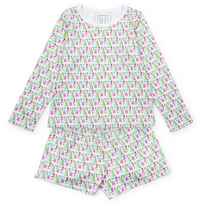 Keep her cozy and stylish this holiday with the Sophie Girls' Lounge Short Set in Mod Holiday Pink by Lila &amp; Hayes. This two-piece set features a long-sleeve top paired with comfortable shorts, designed for relaxed yet vibrant loungewear. The fun retro-inspired print adds a playful touch, making it perfect for festive gatherings or cozy days at home. Let her shine this season with a look that’s as cheerful as it is comfortable.