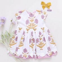 Load image into Gallery viewer, Peek A Boo! Oversized wild dandelions bloom against a 100% cotton vintage cotton voile on our extra special Girls Marisol Dress. Full of surprises, this short sleeve vintage-inspired piece has a purple lining peeking out from behind the scalloped hem and a set of sparkly glitter buttons at the back. 
