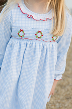 Load image into Gallery viewer, *Pre-Order

Girls Sara Smocked Wreath Long Sleeve Dress from James &amp; Lottie brings festive charm to your little one&#39;s wardrobe. This delightful dress features a soft blue and white gingham knit with hand-smocked Christmas wreaths adorning the front, finished with an elegant ruffle-trimmed collar. Perfect for holiday celebrations and special occasions this season! Coordinate with the matching infant girls bubble to create adorable sibling sets that capture those precious moments together.
