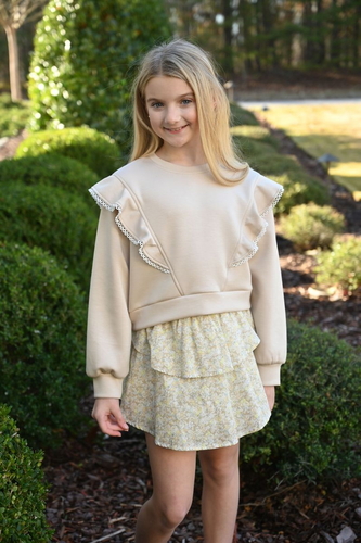 The Parker Shirt in Icy Floral offers a fresh, delicate print that perfectly complements the tiered floral Pleat skirt. Designed for tween girls, this shirt pairs effortlessly with the Livvy Sweatshirt, creating a stylish, coordinated outfit that’s both comfortable and charming. Elevate her wardrobe with this versatile piece that blends sweetness and ease for any occasion.