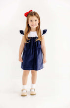 Load image into Gallery viewer, The Beaufort Bonnet Company’s beloved Franny Frock in charming Nantucket Navy with Worth Avenue White and Covington Cottage Plaid is a must-have for every little girl's wardrobe. This adorable girls' dress features a sweet plaid patterned bow that's perfect for tea parties, portraits, and special occasions. It's a timeless piece that brings Southern charm to every wardrobe!

