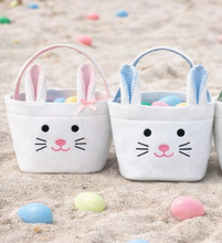 Load image into Gallery viewer, Hippity-hopping its way into our bestselling Bunny Basket assortment, the Bitty Bunny Basket proves that anything is more precious when it’s mini-sized! Cutely crafted of classic pastel seersucker and durable canvas, this portable tiny tote is the perfect accessory for egg hunt adventures for the littlest of tots.  Add a name to the back for that extra special personalized touch!

Easter Bunny-approved bunny face ready for springtime celebrations
Perfect for kids of all ages, especially walkers/toddlers
Gre
