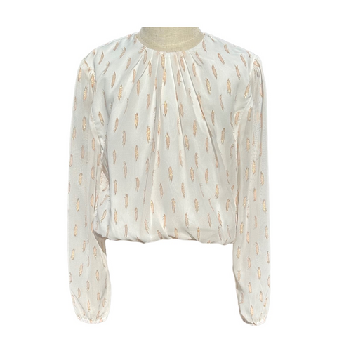 The Wren Top in Dashing is a stunning white chiffon blouse designed for tween girls, featuring a flattering cinched waist and elegant long sleeves. Adorned with subtle gold accents, this dressy piece adds a touch of glamour perfect for fall events and family portraits. Pair it with a tiered skirt to create a captivating look that she’ll love wearing to any special occasion.