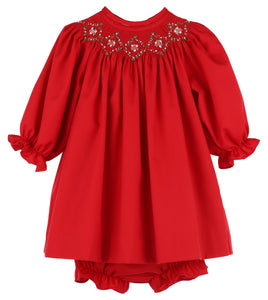 Dress your little one in timeless charm with the Infant Girls Merry &amp; Bright Smocked Bishop Dress from Luli &amp; Me. This bright red bishop dress features delicate hand smocking and embroidery on the neckline, adding a touch of classic elegance. Complete with a matching diaper cover, it ensures both style and comfort for your infant. Perfect for special occasions or festive moments, this dress makes your baby shine with joyful brightness.